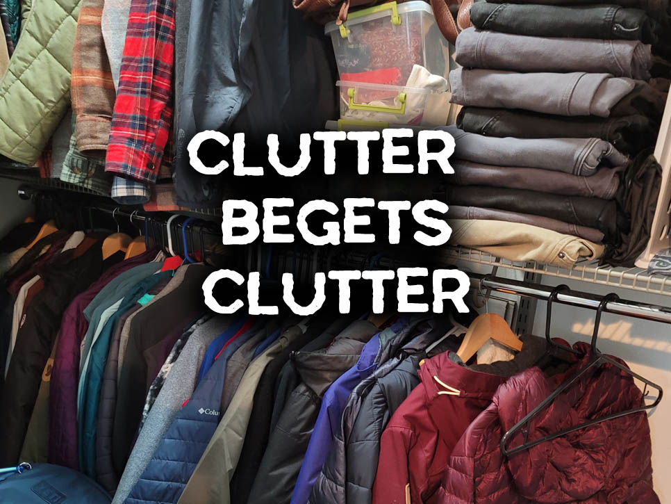 A walk-in closet, full of clothes and clutter